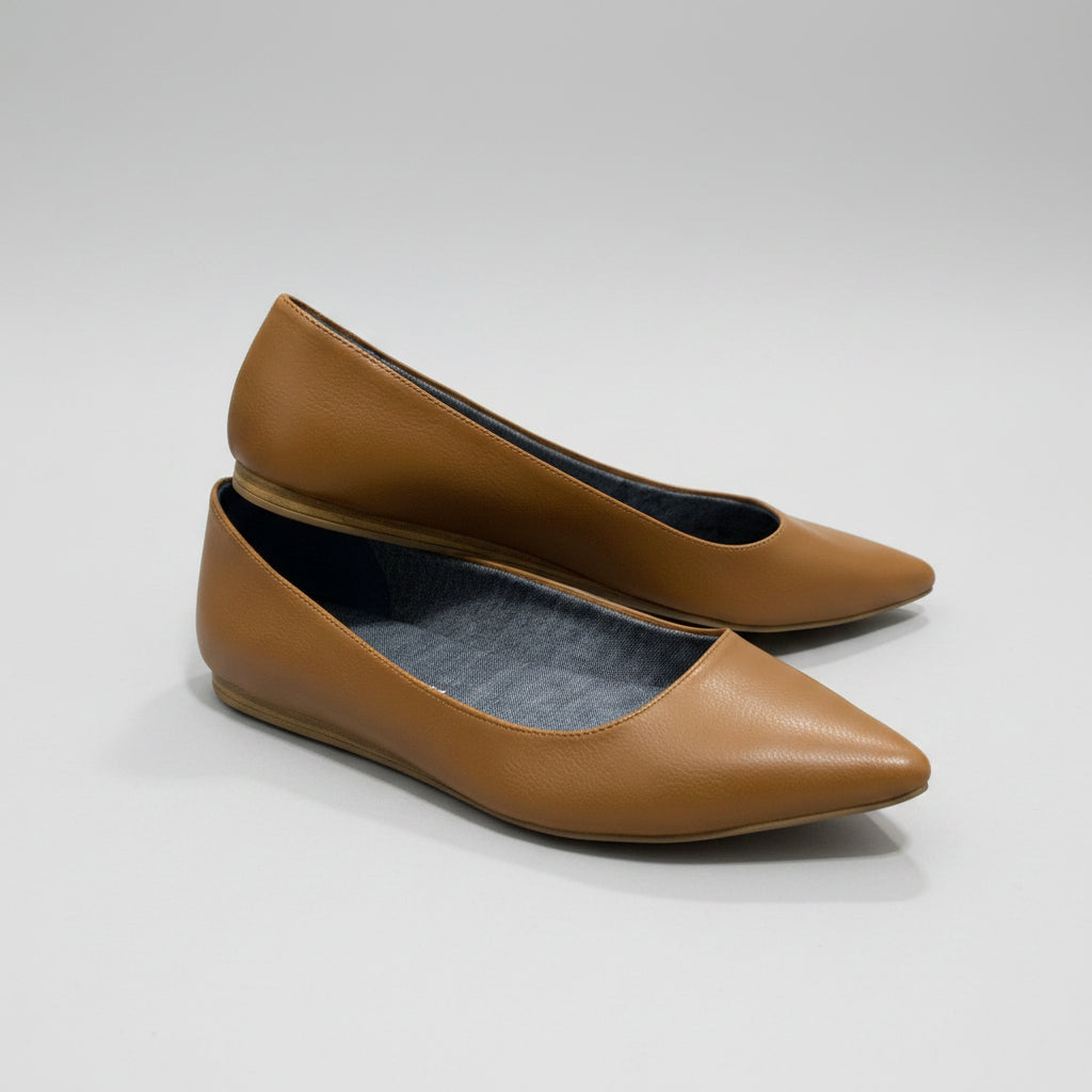 A pair of tan leather pointed-toe flats with a dark gray fabric lining.