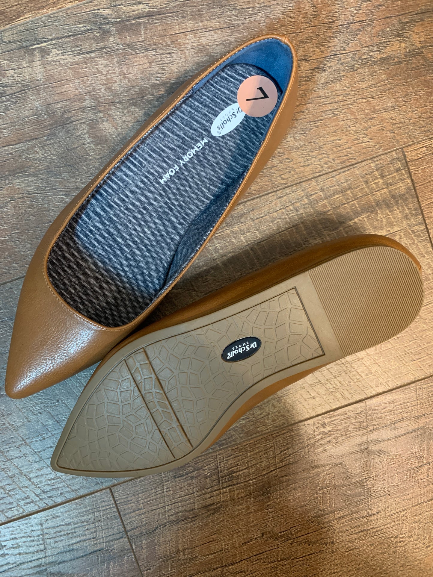 A pair of tan leather pointed-toe flats, one shown from the top and the other from the sole.  The brand name 'Dr. Scholls' is visible on the rubber outsole.