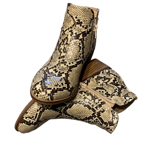A pair of snakeskin-look boots with zippers on the sides.