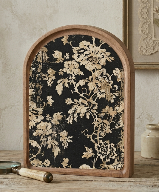 Decorative frame with floral pattern on a wooden surface.